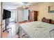 Comfortable bedroom features tile flooring, a ceiling fan, access to outdoor patio, and a wooden wardrobe at 7226 13Th N St, St Petersburg, FL 33702
