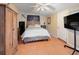 Inviting bedroom features terracotta tile flooring, a ceiling fan, and a wooden wardrobe at 7226 13Th N St, St Petersburg, FL 33702
