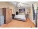 Bright bedroom features wood-look flooring, a ceiling fan, and a stylish wooden bed frame and headboard at 7226 13Th N St, St Petersburg, FL 33702