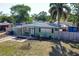 Well-kept single Gathering home with an inviting front yard, a bench, and mature landscaping at 7226 13Th N St, St Petersburg, FL 33702
