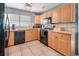 Bright kitchen featuring black appliances, tile flooring, and ample counter space with wooden cabinets at 7226 13Th N St, St Petersburg, FL 33702