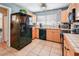 Well-lit kitchen with black appliances, wood cabinets, and plenty of counter space for cooking at 7226 13Th N St, St Petersburg, FL 33702
