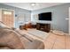 Cozy living room with a neutral color scheme and a view of the front door and large television at 7226 13Th N St, St Petersburg, FL 33702