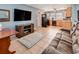 Open-concept living room seamlessly transitions into the kitchen, featuring tile floors and modern appliances at 7226 13Th N St, St Petersburg, FL 33702