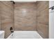 Tiled shower-tub featuring bronze fixtures at 2353 Shelley St # 21, Clearwater, FL 33765