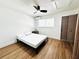 Bedroom with ceiling fan, mini-split air conditioner and wood-look flooring at 2353 Shelley St # 21, Clearwater, FL 33765
