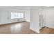 Sunny living room with wood-look flooring, a window AC unit, and an adjacent kitchen at 2353 Shelley St # 21, Clearwater, FL 33765