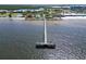 Aerial view of a long pier extending into the calm waters of the beach at 603 Bahia Beach Blvd, Ruskin, FL 33570