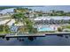 Aerial shot of a waterfront property with a swimming pool, a restaurant and boat docks at 603 Bahia Beach Blvd, Ruskin, FL 33570