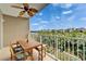 Scenic balcony featuring a wooden table and chairs, perfect for enjoying the waterfront view and beautiful sky at 603 Bahia Beach Blvd, Ruskin, FL 33570