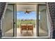 Relaxing outdoor balcony with a charming dining set, string lights and a view of lush greenery and water at 603 Bahia Beach Blvd, Ruskin, FL 33570