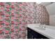 Fun bathroom with vibrant flamingo wallpaper, white vanity, and a large mirror at 603 Bahia Beach Blvd, Ruskin, FL 33570
