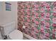 Charming powder room with whimsical flamingo wallpaper and a modern white toilet at 603 Bahia Beach Blvd, Ruskin, FL 33570