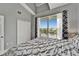 Beautifully appointed bedroom featuring balcony access, a large window with a waterfront view and a spacious closet at 603 Bahia Beach Blvd, Ruskin, FL 33570