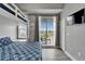 Bedroom with bunk bed, balcony access, and stylish decor, offering comfort and a great view at 603 Bahia Beach Blvd, Ruskin, FL 33570
