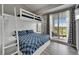 Bright bedroom featuring a bunk bed with a large window offering exterior views at 603 Bahia Beach Blvd, Ruskin, FL 33570