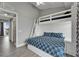 A bedroom with a bunk bed and a double bed featuring nautical-themed bedding and a door to the balcony at 603 Bahia Beach Blvd, Ruskin, FL 33570
