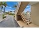 Exterior staircase and walkway featuring white railings that lead to the charming condos at 603 Bahia Beach Blvd, Ruskin, FL 33570