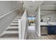 Bright hallway and stairs leading to an open-concept living space with stainless steel appliances and a view at 603 Bahia Beach Blvd, Ruskin, FL 33570