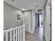 Inviting hallway featuring wood floors, a closet, and a glimpse of the balcony at 603 Bahia Beach Blvd, Ruskin, FL 33570