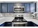 Well-equipped kitchen with stainless steel appliances and sleek countertops, ready for meal preparation at 603 Bahia Beach Blvd, Ruskin, FL 33570