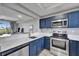 Modern kitchen with stainless steel appliances, breakfast bar, and an open view of the living area at 603 Bahia Beach Blvd, Ruskin, FL 33570