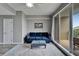 Cozy living room with a comfortable blue sofa, a stylish area rug and sliding doors to the balcony at 603 Bahia Beach Blvd, Ruskin, FL 33570