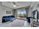 Cozy living room with blue furniture, ceiling fan, and balcony offering tranquil views at 603 Bahia Beach Blvd, Ruskin, FL 33570