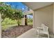 Outdoor patio area with seating surrounded by lush landscaping and mature trees at 603 Bahia Beach Blvd, Ruskin, FL 33570