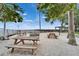 Outdoor picnic area with tables, fire pit, and glimpses of the water at 603 Bahia Beach Blvd, Ruskin, FL 33570