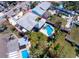 Aerial view of the property showcasing its pool, lot size, and proximity to neighboring homes at 855 Boca Ciega Isle Dr, St Pete Beach, FL 33706