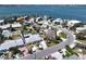 Aerial shot showcasing neighborhood homes near bay waters and coastline in a waterfront community at 855 Boca Ciega Isle Dr, St Pete Beach, FL 33706