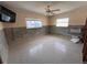 Bedroom with terrazzo flooring, an AC unit, and lots of natural light, ready for an update at 855 Boca Ciega Isle Dr, St Pete Beach, FL 33706