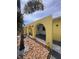 Exterior view showing covered area with arched openings and decorative stone landscaping at 855 Boca Ciega Isle Dr, St Pete Beach, FL 33706
