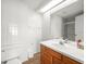 Bright bathroom features white tiled walls, a skylight, and a classic vanity at 9100 Suffolk Ln, Port Richey, FL 34668