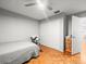 Bedroom features parquet floors, white walls, and closet at 9100 Suffolk Ln, Port Richey, FL 34668