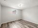 Neutral bedroom with wood flooring and a window, offering a simple, calming space at 9100 Suffolk Ln, Port Richey, FL 34668