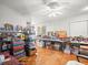 Large living room with parquet floors, white walls and a ceiling fan at 9100 Suffolk Ln, Port Richey, FL 34668