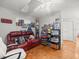Living room featuring parquet floors, red leather sofa and ceiling fan at 9100 Suffolk Ln, Port Richey, FL 34668