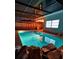 Inviting pool with turquoise water, set in a screened enclosure, featuring a rock detail in the foreground at 9100 Suffolk Ln, Port Richey, FL 34668