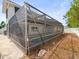 Side view of the enclosed pool in a screened patio at 9100 Suffolk Ln, Port Richey, FL 34668