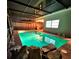 A beautifully lit in-ground pool with an inviting screened-in lanai for relaxation and entertainment at 9100 Suffolk Ln, Port Richey, FL 34668