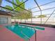 This screened pool offers a relaxing oasis with a decorative rock water feature at 9100 Suffolk Ln, Port Richey, FL 34668