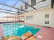 A refreshing backyard pool enclosed with a screen offers a private retreat at 9100 Suffolk Ln, Port Richey, FL 34668