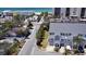 Aerial view of light blue two-story townhouses near white sand and the ocean at 900 Harbour House Dr, Indian Rocks Beach, FL 33785