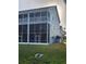 Back screened in porch with a green backyard at 900 Harbour House Dr, Indian Rocks Beach, FL 33785