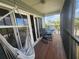Relaxing balcony featuring two rocking chairs, a hammock, and views of the tropical foliage at 900 Harbour House Dr, Indian Rocks Beach, FL 33785