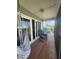 Relaxing balcony features a hammock and rocking chairs with a pleasant outdoor view at 900 Harbour House Dr, Indian Rocks Beach, FL 33785