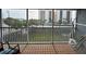 Screened-in balcony features comfortable seating and a hammock with views of the surrounding cityscape and lush greenery at 900 Harbour House Dr, Indian Rocks Beach, FL 33785