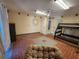 Spacious basement featuring unique tile flooring, a bunk bed, and a comfortable papasan chair at 900 Harbour House Dr, Indian Rocks Beach, FL 33785
